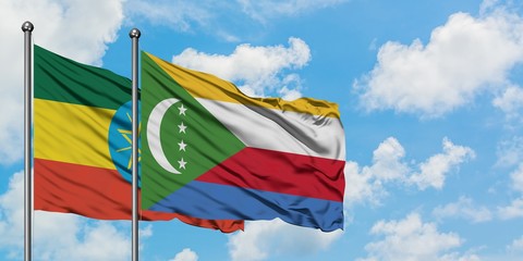Ethiopia and Comoros flag waving in the wind against white cloudy blue sky together. Diplomacy...