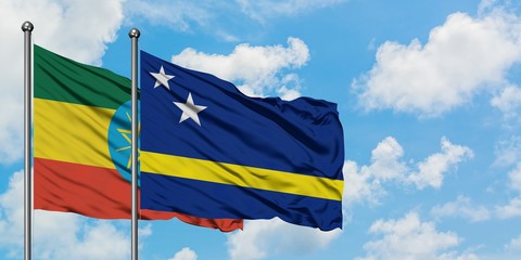 Ethiopia and Curacao flag waving in the wind against white cloudy blue sky together. Diplomacy concept, international relations.