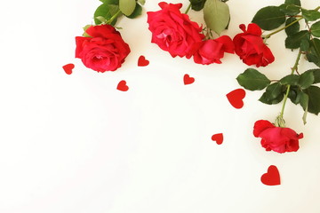 Red roses and red hearts composition on white background top view. Valentine's day, birthday, wedding, Mother's day concept. Copy space