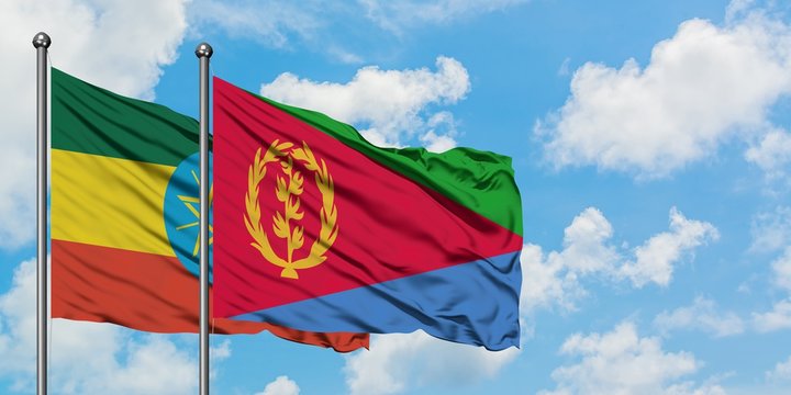 Ethiopia and Eritrea flag waving in the wind against white cloudy blue sky together. Diplomacy concept, international relations.
