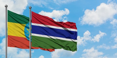 Ethiopia and Gambia flag waving in the wind against white cloudy blue sky together. Diplomacy concept, international relations.