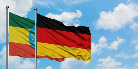 Ethiopia and Germany flag waving in the wind against white cloudy blue sky together. Diplomacy concept, international relations.