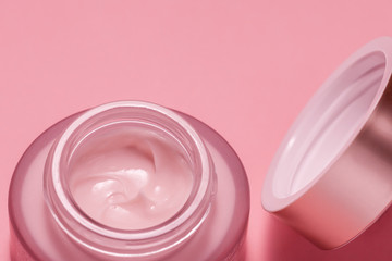 Cosmetic cream in a can on a pink background