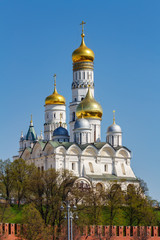 Fototapeta na wymiar Cathedral of the Archangel and Ivan the Great Bell-Tower against Moscow Kremlin wall in sunny spring morning