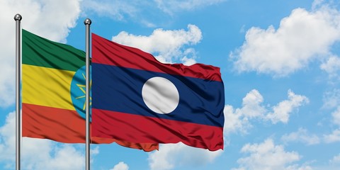 Ethiopia and Laos flag waving in the wind against white cloudy blue sky together. Diplomacy concept, international relations.