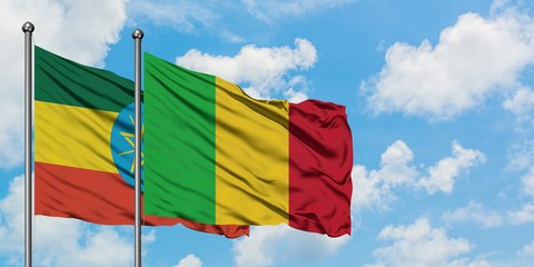 Ethiopia and Mali flag waving in the wind against white cloudy blue sky together. Diplomacy concept, international relations.