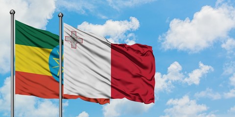 Ethiopia and Malta flag waving in the wind against white cloudy blue sky together. Diplomacy concept, international relations.