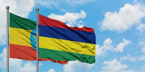 Ethiopia and Mauritius flag waving in the wind against white cloudy blue sky together. Diplomacy concept, international relations.