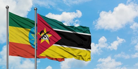 Ethiopia and Mozambique flag waving in the wind against white cloudy blue sky together. Diplomacy concept, international relations.
