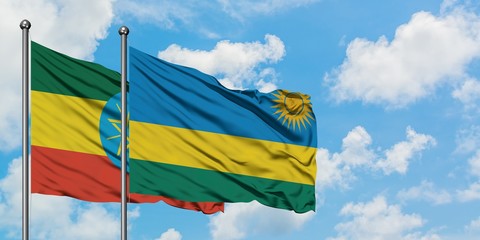 Ethiopia and Rwanda flag waving in the wind against white cloudy blue sky together. Diplomacy concept, international relations.