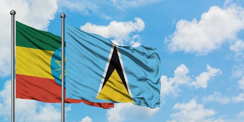 Ethiopia and Saint Lucia flag waving in the wind against white cloudy blue sky together. Diplomacy concept, international relations.