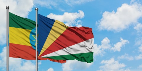 Ethiopia and Seychelles flag waving in the wind against white cloudy blue sky together. Diplomacy concept, international relations.