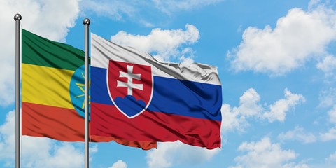 Ethiopia and Slovakia flag waving in the wind against white cloudy blue sky together. Diplomacy concept, international relations.