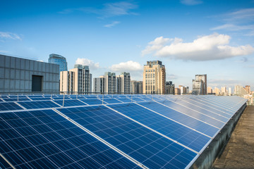 Photovoltaic panels in front of city background