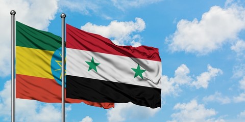 Ethiopia and Syria flag waving in the wind against white cloudy blue sky together. Diplomacy...