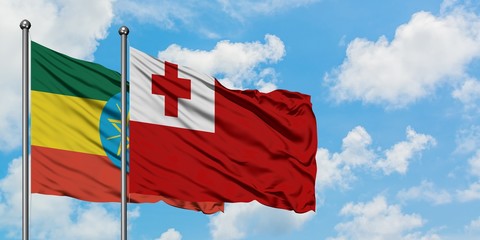 Ethiopia and Tonga flag waving in the wind against white cloudy blue sky together. Diplomacy concept, international relations.