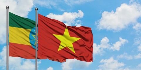 Ethiopia and Vietnam flag waving in the wind against white cloudy blue sky together. Diplomacy concept, international relations.