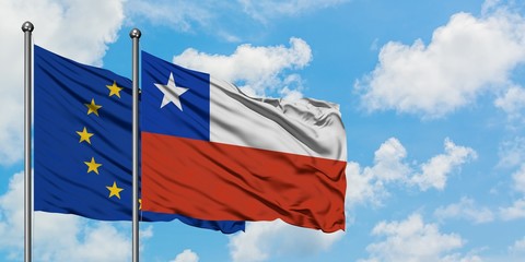 European Union and Chile flag waving in the wind against white cloudy blue sky together. Diplomacy concept, international relations.