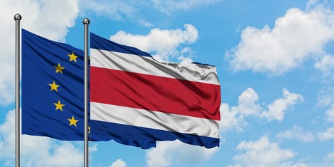 European Union and Costa Rica flag waving in the wind against white cloudy blue sky together. Diplomacy concept, international relations.