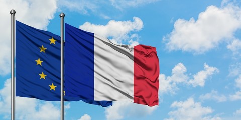 European Union and France flag waving in the wind against white cloudy blue sky together. Diplomacy concept, international relations.