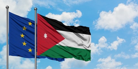 European Union and Jordan flag waving in the wind against white cloudy blue sky together. Diplomacy concept, international relations.