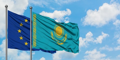 European Union and Kazakhstan flag waving in the wind against white cloudy blue sky together. Diplomacy concept, international relations.
