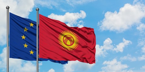 European Union and Kyrgyzstan flag waving in the wind against white cloudy blue sky together. Diplomacy concept, international relations.