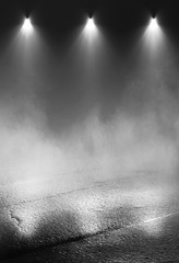 Empty background scene. Dark street reflection on wet asphalt. Rays of neon light in the dark, neon figures, smoke. Background of empty stage show. Abstract dark background.