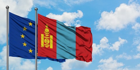 European Union and Mongolia flag waving in the wind against white cloudy blue sky together. Diplomacy concept, international relations.