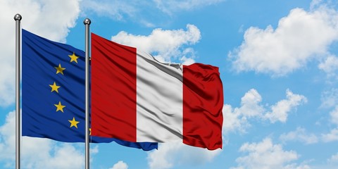 European Union and Peru flag waving in the wind against white cloudy blue sky together. Diplomacy concept, international relations.