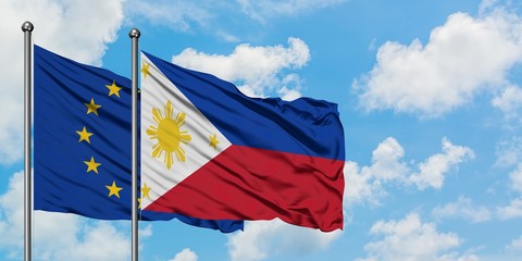 European Union and Philippines flag waving in the wind against white cloudy blue sky together. Diplomacy concept, international relations.