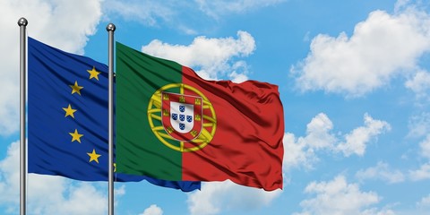 European Union and Portugal flag waving in the wind against white cloudy blue sky together. Diplomacy concept, international relations.