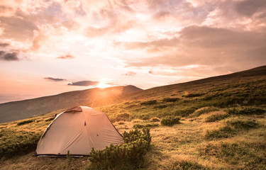 Camping tent in morning sun ray. Active lifestyle. Tatra mountains Zakopane, Poland