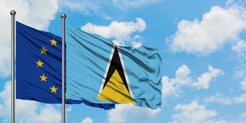 European Union and Saint Lucia flag waving in the wind against white cloudy blue sky together. Diplomacy concept, international relations.