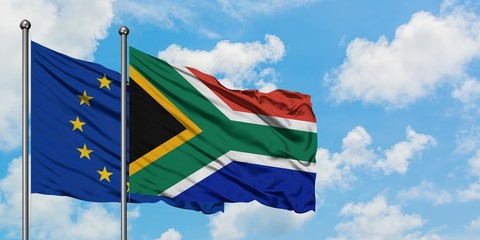 European Union and South Africa flag waving in the wind against white cloudy blue sky together. Diplomacy concept, international relations.