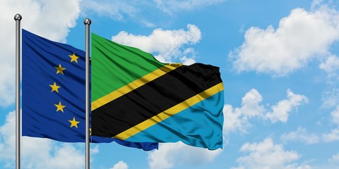 European Union and Tanzania flag waving in the wind against white cloudy blue sky together. Diplomacy concept, international relations.