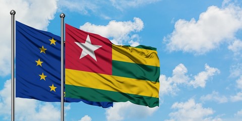 European Union and Togo flag waving in the wind against white cloudy blue sky together. Diplomacy concept, international relations.