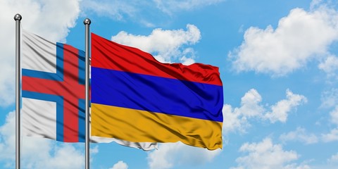 Faroe Islands and Armenia flag waving in the wind against white cloudy blue sky together. Diplomacy concept, international relations.