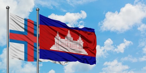 Faroe Islands and Cambodia flag waving in the wind against white cloudy blue sky together....