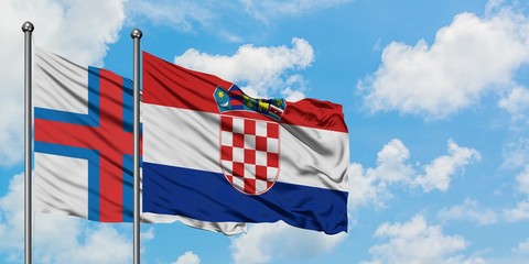 Faroe Islands and Croatia flag waving in the wind against white cloudy blue sky together. Diplomacy concept, international relations.