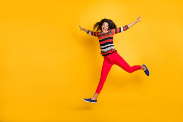 Full length profile side photo of crazy funky brunette hair girl carefree jump run with hold hands feel candid emotions scream wear casual style outfit isolated over yellow color background