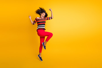 Fototapeta na wymiar Full length photo of crazy delighted afro american girl win lottery jackpot raise fists scream yeah wear casual style jumper isolated over yellow color background