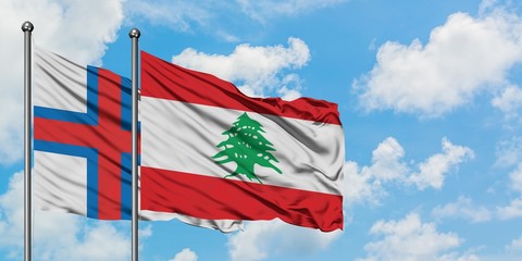 Faroe Islands and Lebanon flag waving in the wind against white cloudy blue sky together. Diplomacy concept, international relations.