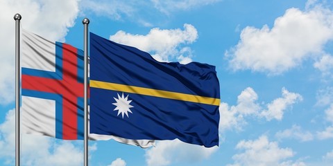 Faroe Islands and Nauru flag waving in the wind against white cloudy blue sky together. Diplomacy...