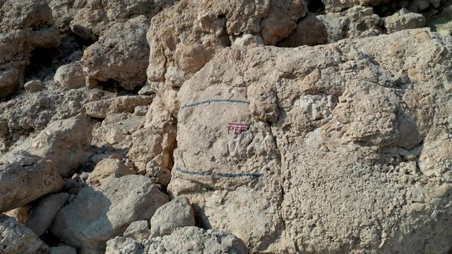 Super Pull Out aerial shot from PEF mark, over green vegetation until the Dead sea wide view  revealed with the red mountains in the background
