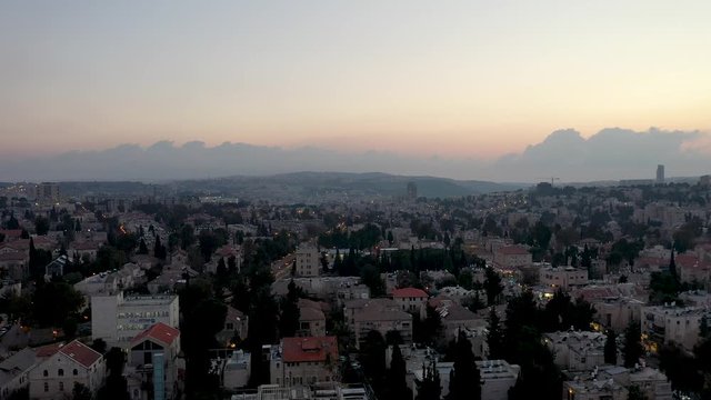 Aerial fly down shot over Jerusalem Nachlaot neighborhood at sunset, Israel