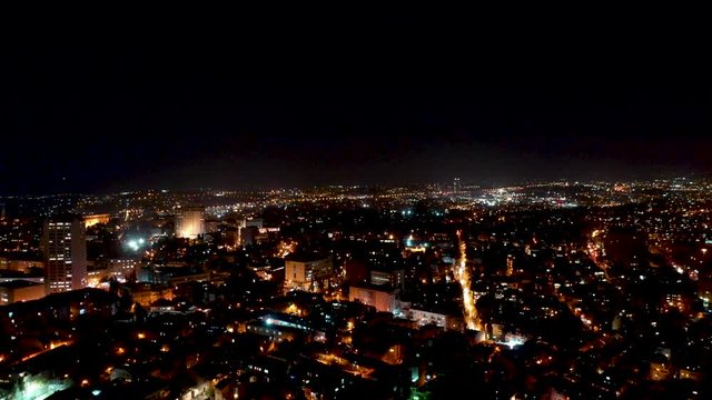 Aerial fly down shot over Jerusalem night lighted city center