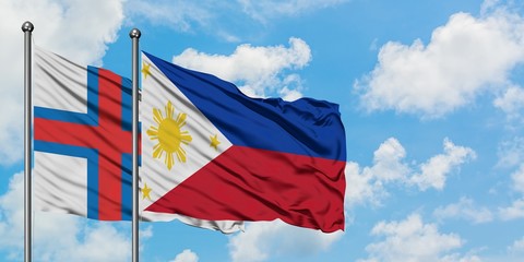 Faroe Islands and Philippines flag waving in the wind against white cloudy blue sky together. Diplomacy concept, international relations.