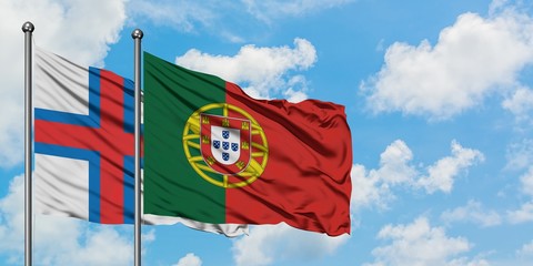 Faroe Islands and Portugal flag waving in the wind against white cloudy blue sky together. Diplomacy concept, international relations.