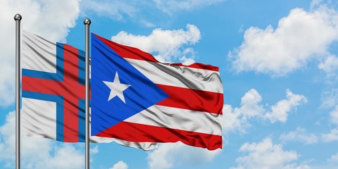 Faroe Islands and Puerto Rico flag waving in the wind against white cloudy blue sky together. Diplomacy concept, international relations.
